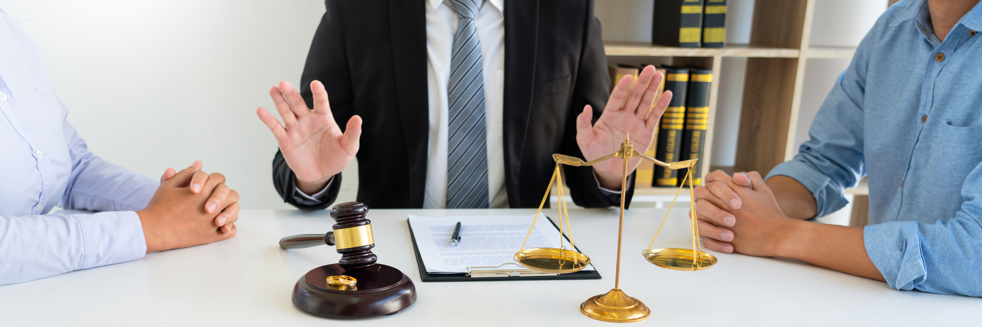 Lawyer Mediating Between Couple in Divorce Hearing